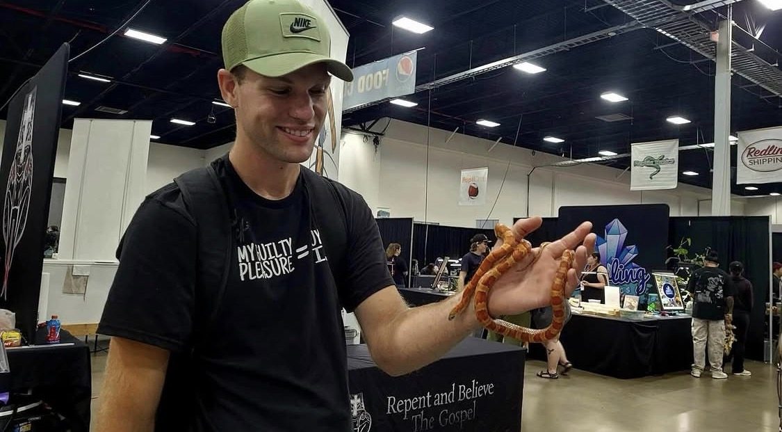 Evan carefully holding a snake
